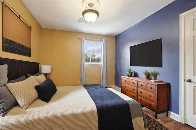 bedroom with wood-type flooring