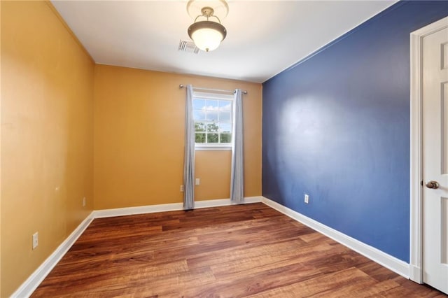 unfurnished room with wood-type flooring