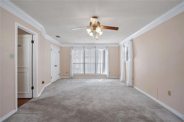 carpeted empty room with ceiling fan, crown molding, and a textured ceiling