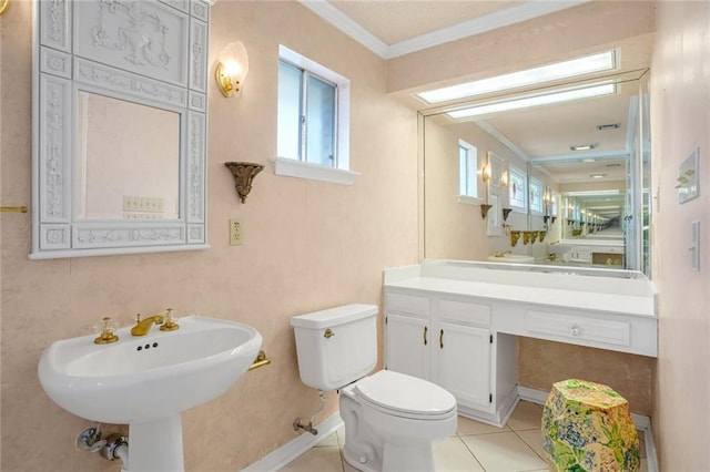 bathroom featuring crown molding, tile patterned floors, and toilet