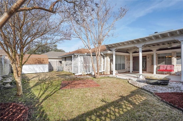 view of yard with central AC, ceiling fan, and a patio area