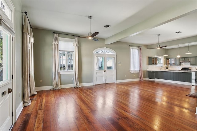 foyer with visible vents, ceiling fan, and hardwood / wood-style flooring