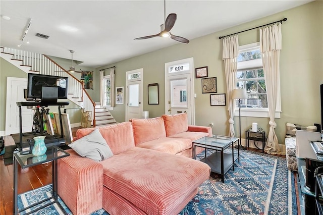 living room with ceiling fan, wood-type flooring, and track lighting