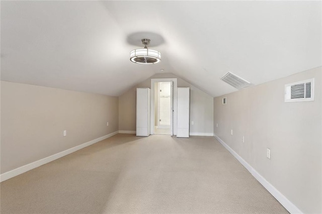 bonus room featuring visible vents, baseboards, and lofted ceiling
