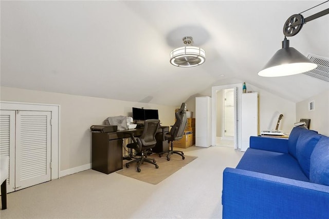 carpeted office space with vaulted ceiling and visible vents