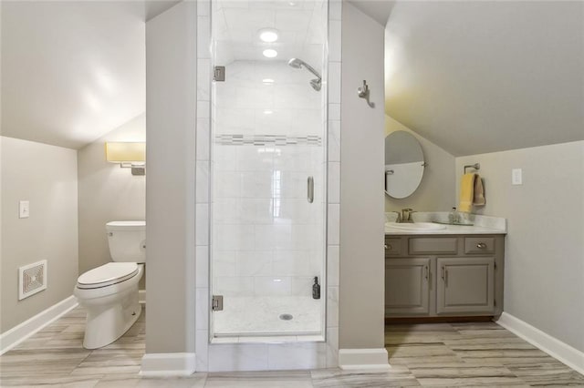 bathroom with lofted ceiling, hardwood / wood-style flooring, vanity, an enclosed shower, and toilet