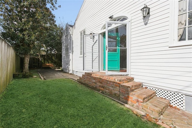exterior space featuring fence and a yard