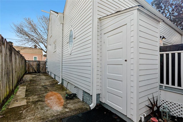 view of side of property featuring fence, a gate, and a garage