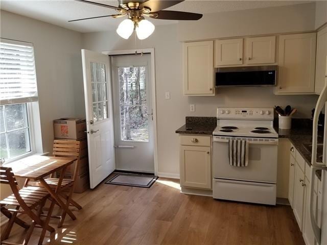 kitchen featuring ventilation hood, light hardwood / wood-style flooring, ceiling fan, white range with electric stovetop, and white cabinets