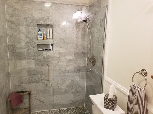 bathroom featuring a shower with shower door