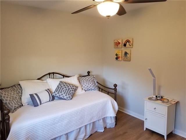 bedroom featuring ceiling fan and dark hardwood / wood-style floors