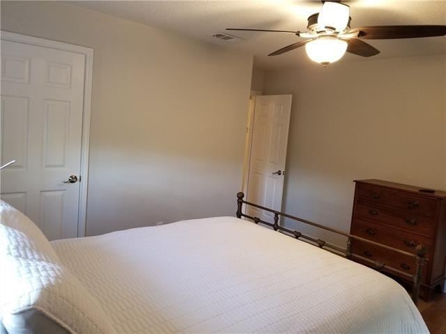 bedroom with hardwood / wood-style flooring and ceiling fan