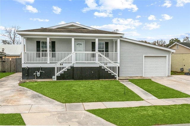 view of front of home featuring a garage, a front lawn, and a porch