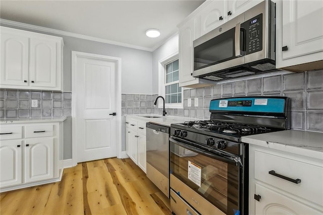 kitchen with white cabinetry, appliances with stainless steel finishes, and sink