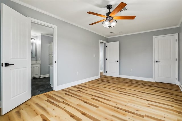 unfurnished bedroom featuring crown molding, ceiling fan, ensuite bathroom, and light hardwood / wood-style floors