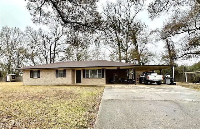 view of front of property featuring a carport and a storage shed