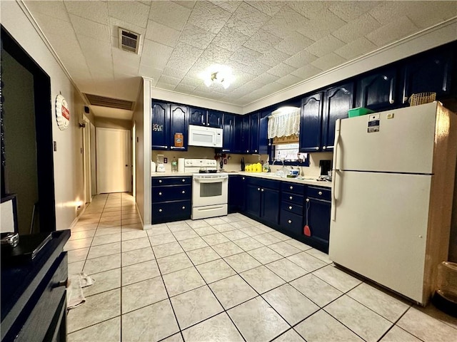 kitchen featuring light tile patterned flooring, blue cabinetry, and white appliances