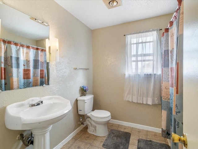 bathroom featuring tile patterned floors and toilet