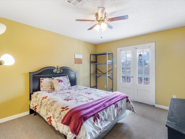 carpeted bedroom with ceiling fan, access to outside, and a textured ceiling