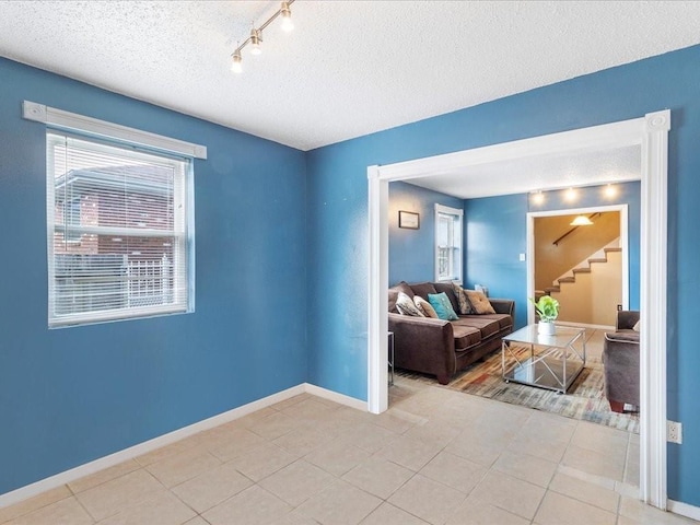 tiled living room with a textured ceiling