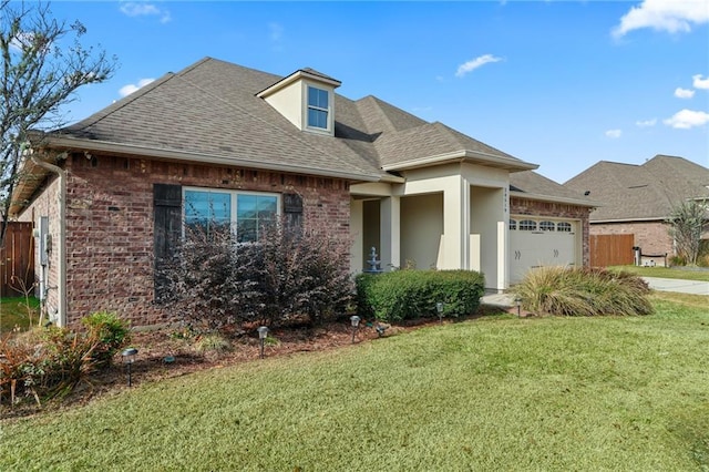 view of front of home with a garage and a front lawn