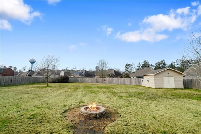 view of yard featuring an outdoor structure and a fire pit