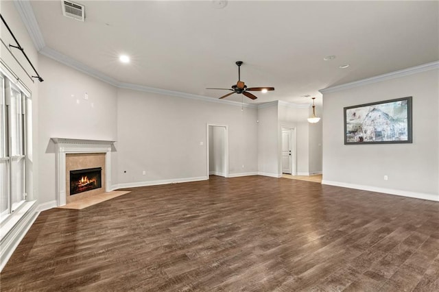 unfurnished living room featuring a premium fireplace, dark hardwood / wood-style floors, ceiling fan, and crown molding