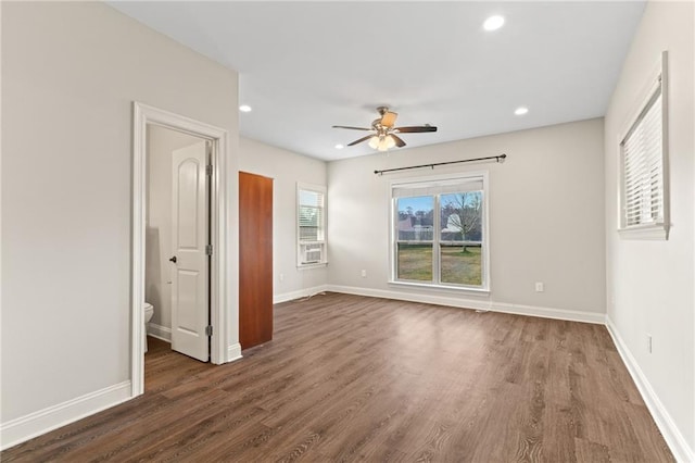 unfurnished bedroom with ceiling fan, connected bathroom, and dark hardwood / wood-style flooring