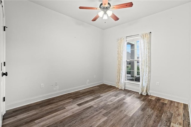 spare room with ceiling fan and dark hardwood / wood-style flooring