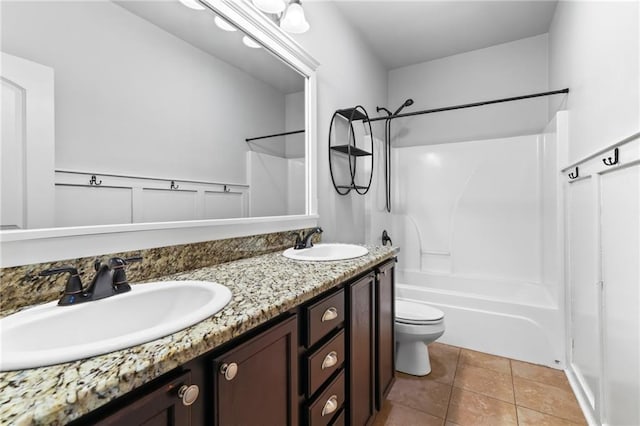 full bathroom featuring tile patterned flooring, vanity,  shower combination, and toilet