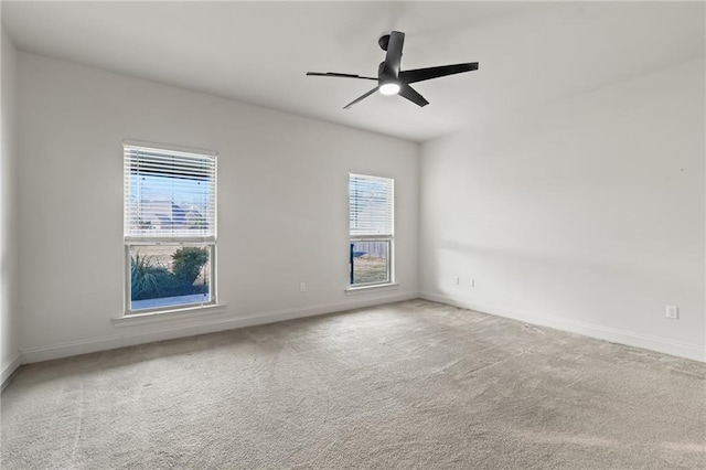 carpeted spare room with ceiling fan