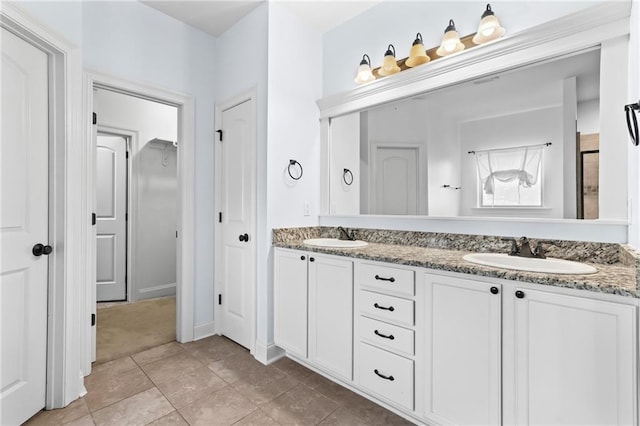 bathroom featuring vanity, a shower with shower door, and tile patterned flooring