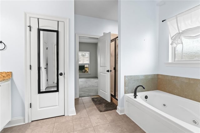 bathroom featuring plenty of natural light, tile patterned floors, and separate shower and tub