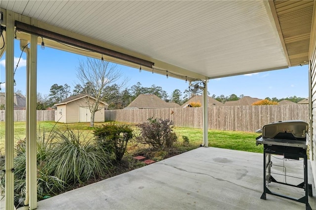 view of patio / terrace with grilling area and a shed