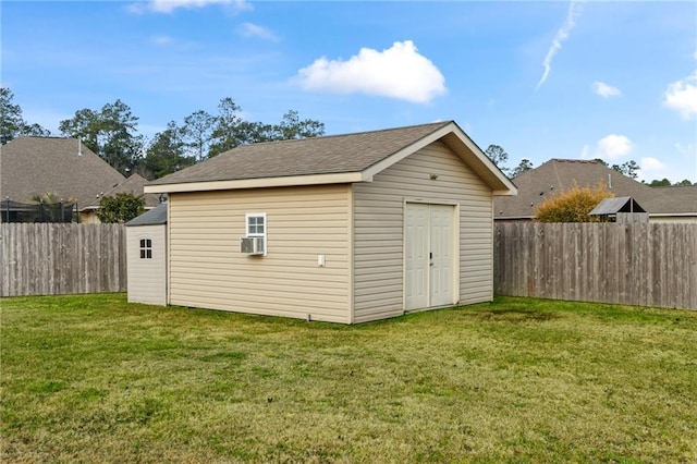 view of outdoor structure with a yard and cooling unit