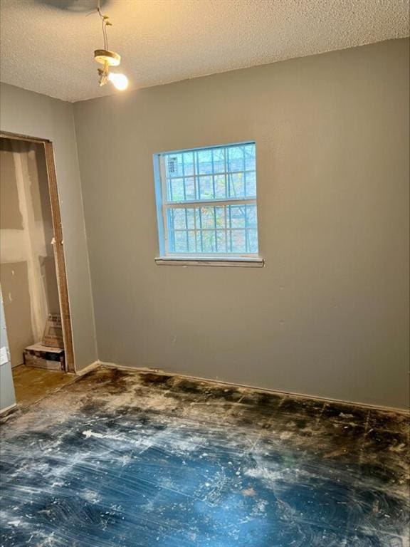 spare room featuring a textured ceiling