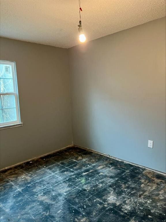 empty room featuring a textured ceiling