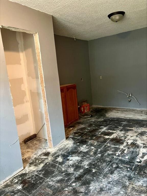 spare room featuring a textured ceiling