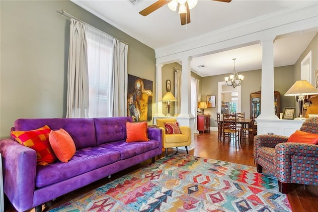 living room with decorative columns, a wealth of natural light, and hardwood / wood-style floors