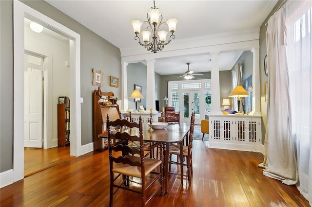 dining area featuring ornate columns, hardwood / wood-style floors, ceiling fan, and french doors