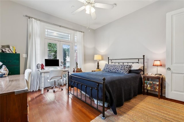 bedroom with hardwood / wood-style floors, french doors, and ceiling fan