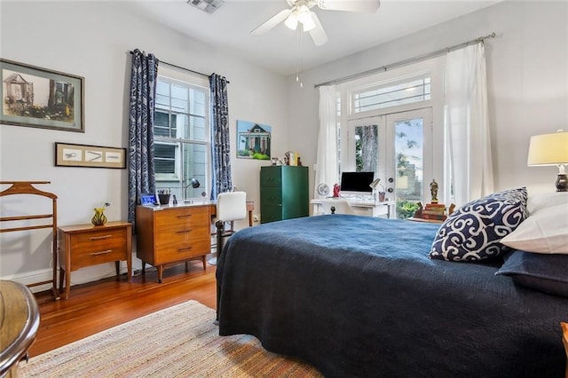 bedroom with access to exterior, light hardwood / wood-style floors, french doors, and ceiling fan