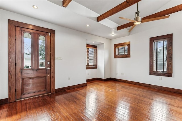 entrance foyer with dark hardwood / wood-style flooring, plenty of natural light, and lofted ceiling with beams