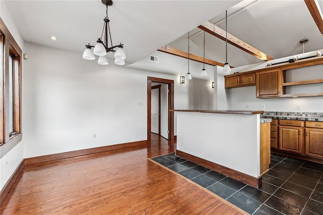 kitchen featuring dark hardwood / wood-style floors, a chandelier, and decorative light fixtures