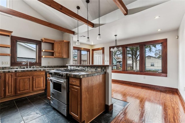 kitchen with dark hardwood / wood-style floors, pendant lighting, sink, vaulted ceiling with beams, and high end stainless steel range oven