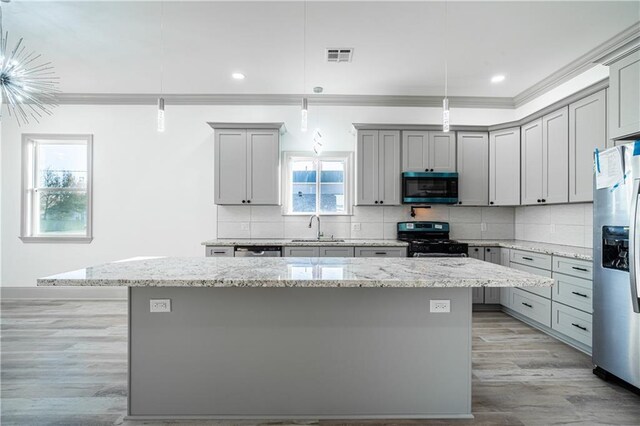 26 Carroll Dr, Chalmette, LA 70043 - kitchen with appliances with stainless steel finishes, gray cabinets, crown molding, a sink, and a kitchen island