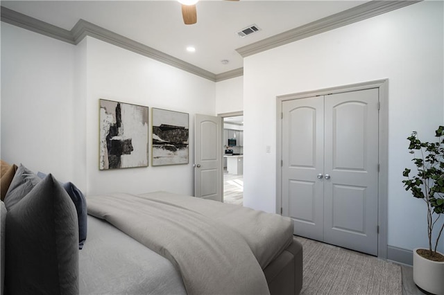 26 Carroll Dr, Chalmette, LA 70043 - carpeted bedroom with crown molding, a closet, and a ceiling fan