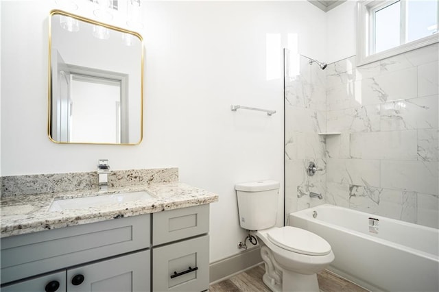 full bathroom with vanity, toilet, tiled shower / bath combo, and wood-type flooring