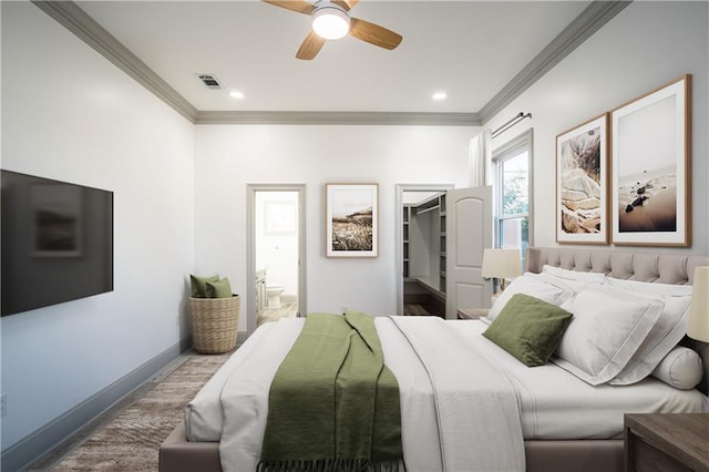 26 Carroll Dr, Chalmette, LA 70043 - bedroom with ornamental molding, a walk in closet, baseboards, ensuite bath, and a ceiling fan