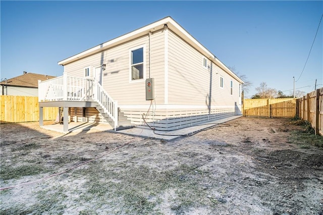 26 Carroll Dr, Chalmette, LA 70043 - back of property featuring a fenced backyard, a wooden deck, and stairway
